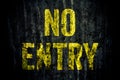 Ã¢â¬ÅNo EntryÃ¢â¬Â warning sign in yellow letters painted over dark grungy grey concrete wall Royalty Free Stock Photo